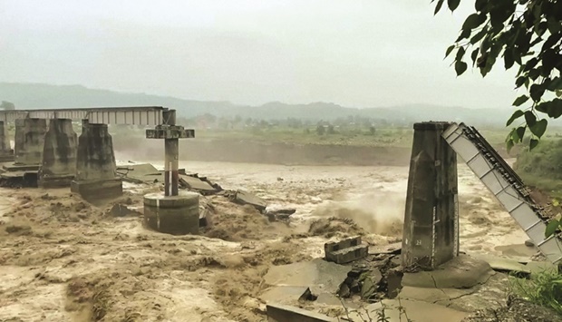 A bridge collapses following heavy rains in Kangra, Himachal Pradesh, India.
