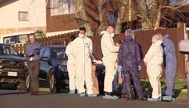 Police and forensic investigators gather at the scene where suitcases with the remains of two children were found, after a family, who are not connected to the deaths, bought them at an online auction for an unclaimed locker, in Auckland, New Zealand on August 11, in this still image taken from video. TVNZ/Handout via REUTERS TV
