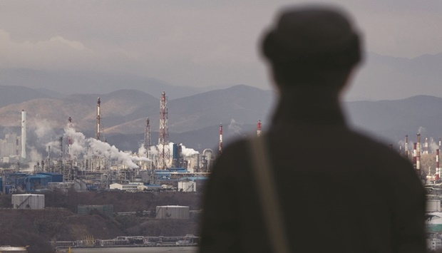 A man looks out from an observatory as smoke billows from SK Innovation Cou2019s Ulsan Complex oil refinery facilities in Ulsan, South Korea (file). A suggestion from Saudi Arabia that Opec+ may cut oil output has startled refiners in Asia, with two warning such a move could lift prices and fan uncertainty at an already-difficult time for processors in the biggest crude-importing region.