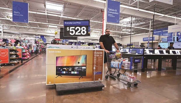 A man pushes his cart through a store in Rosemead, California (file). The US economy contracted at a more moderate pace than initially thought in the second quarter as consumer spending blunted some of the drag from a slower pace of inventory accumulation, dispelling fears that a recession was underway.
