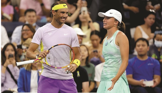 Rafael Nadal (left) of Spain and Iga Swiatek of Poland talk before their match against John McEnroe and Coco Gauff during Tennis Plays For Peace exhibition match to benefit Ukraine in New York City on Wednesday. (AFP)