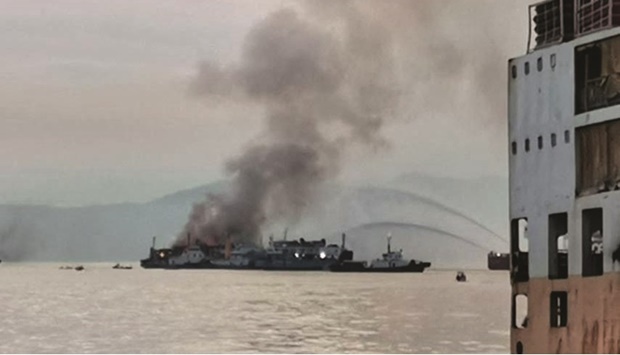 Smoke billows from the shipping vessel at an anchorage area in Batangas, Philippines, yesterday.