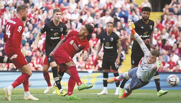 Liverpoolu2019s Roberto Firmino (second left) scores his teamu2019s seventh goal against Bournemouth during the Premier League match at the Anfield in Liverpool, Britain, yesterday. (Reuters)