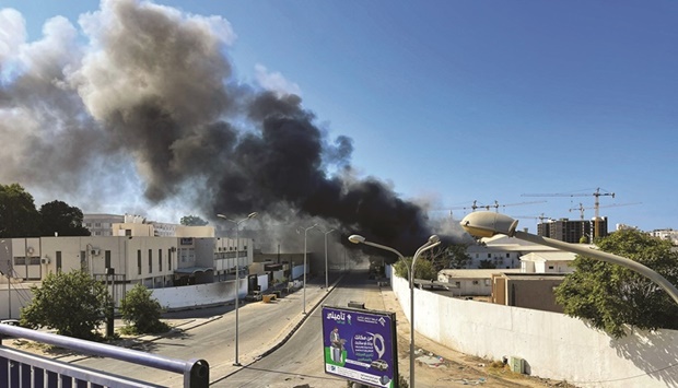 Smoke rises in the sky following clashes in Tripoli, Libya.