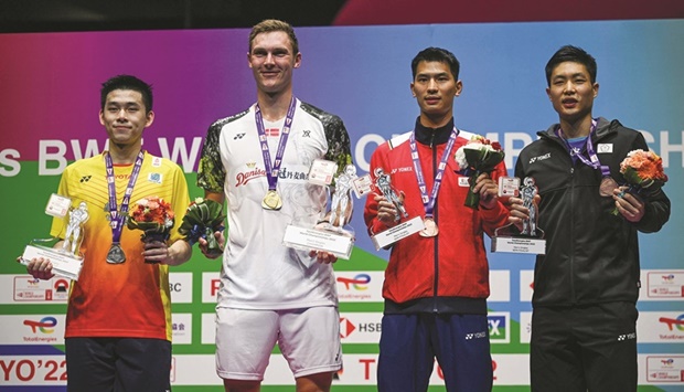 Gold medallist Viktor Axelsen of Denmark (second left) poses on the podium with silver medallist Kunlavut Vitidsarn of Thailand (left) and bronze medallists Zhao Junpeng of China (second right) and Chou Tien-chen of Taiwan after the menu2019s singles final at the World Badminton Championships in Tokyo yesterday. (AFP)