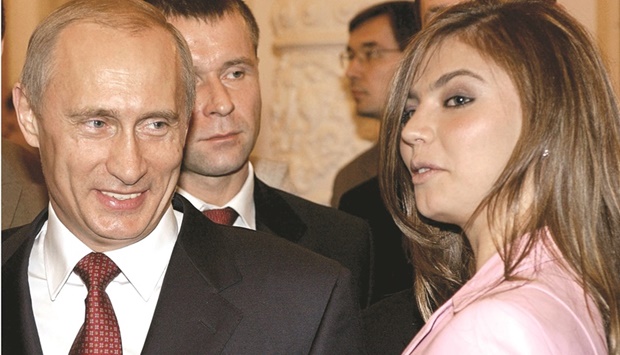 Russian President Vladimir Putin smiles next to Russian gymnast Alina Kabaeva during a meeting with the Russian Olympic team at the Kremlin in Moscow in this November 4, 2004 file photo. (Reuters)