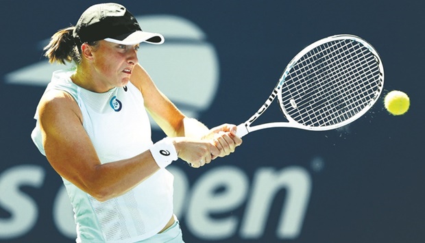 Top seed Iga Swiatek of Poland plays a backhand against Jasmine Paolini of Italy in their first-round match at the US Open in New York. (AFP)