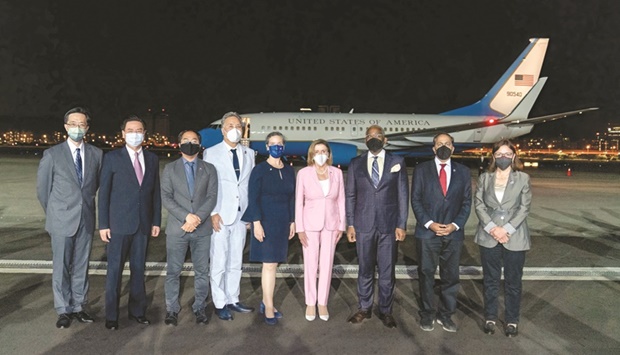 Taiwan Foreign Minister Joseph Wu poses for a group photo with Pelosi and other members of the delegation at Taipei Songshan Airport yesterday