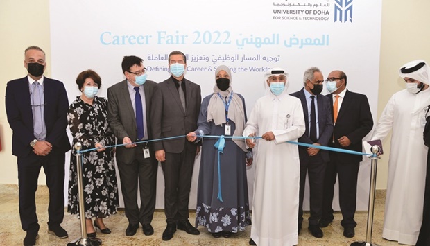 Dr Salem Al-Naemi along with other officials opens the career fair by cutting a ribbon.