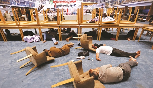 Supporters of Iraqi populist leader Moqtada al-Sadr sleep during a sit-in at the parliament building, amid political crisis in Baghdad, Iraq.