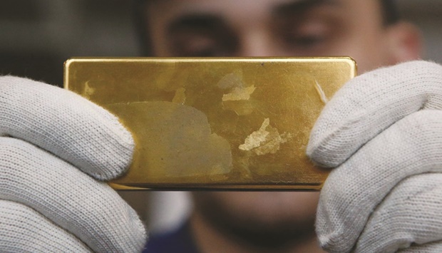 An employee shows gold bar at the Prioksky Non-Ferrous Metals Plant in Kasimov, Russia. (Reuters file photo)