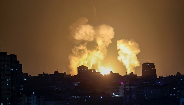 Smoke and fire rises following Israeli airstrikes on a building in Gaza City late Friday.