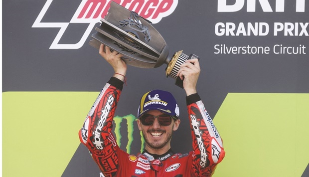 Ducati Lenovou2019s Francesco Bagnaia celebrates winning the British Grand Prix with the trophy at the Silverstone Circuit in Britain yesterday. (Reuters)