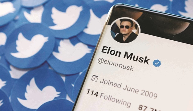 Elon Musku2019s Twitter profile is seen on a smartphone placed on printed Twitter logos in this picture illustration taken April 28, 2022. (Reuters)