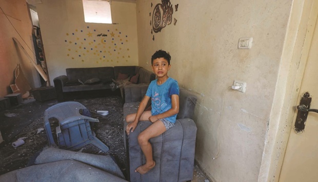 A Palestinian boy looks on in fear as his family house is damaged amid Israel-Gaza fighting, in the northern Gaza Strip, yesterday.