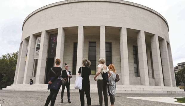 Danijela Matijevic (second left) gives explanations in front of the Mestrovic Pavilion, the former Museum of the Revolution, at the start of a walking historic tour telling the story of late Yugoslav leader Josip Broz Tito in Zagreb, Croatia. (AFP)