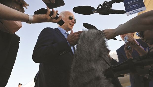 Biden speaks with reporters before departing Dover Air Force Base, Delaware, to visit families in Kentucky impacted by floods.
