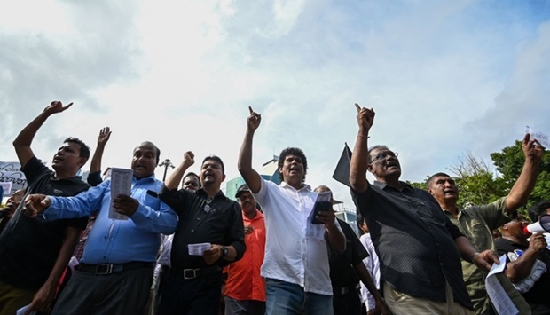 Protestors participate in an anti-government demonstration in Colombo. AFP