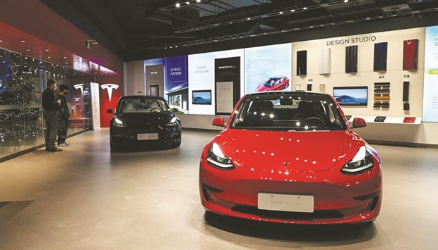Tesla Model 3 cars are seen at a Tesla showroom at a shopping mall in Beijing. Tesla has delivered 28,217 cars, with 8,461 going to the local market and 19,756 exported, mostly to Europe and Asia.