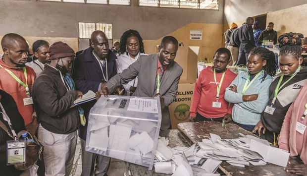 An electoral commission official proceeds to count votes after the official closing of polls during Kenyau2019s general election at Mathare Social Hall in Nairobi, Kenya, yesterday.