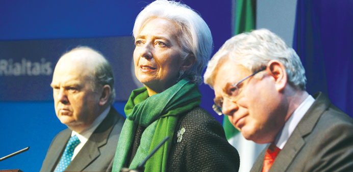 Lagarde speaks to journalists during a press conference in Dublin, yesterday, flanked by Irish Deputy Prime Minister Eamon Gilmore (right) and Irish M