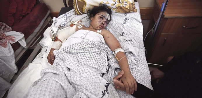 Nine-year-old Hanen al-Bakri receives treatment at Shifa hospital in Gaza City yesterday. Haneen and her sister Yasmin, 11, were injured in an Israeli