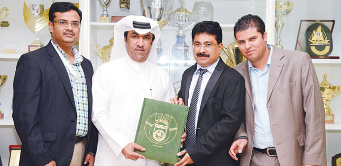 QIFF officials pose with Al Ahli Audience and Marketing Manager Nasser Yakoub after signing the agreement.