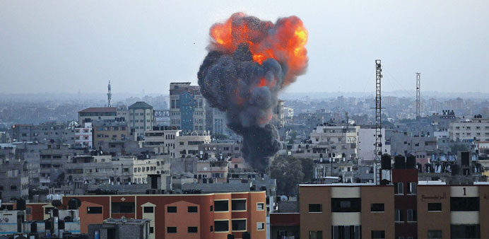 Smoke rises after Israeli air strikes in Gaza City yesterday.
