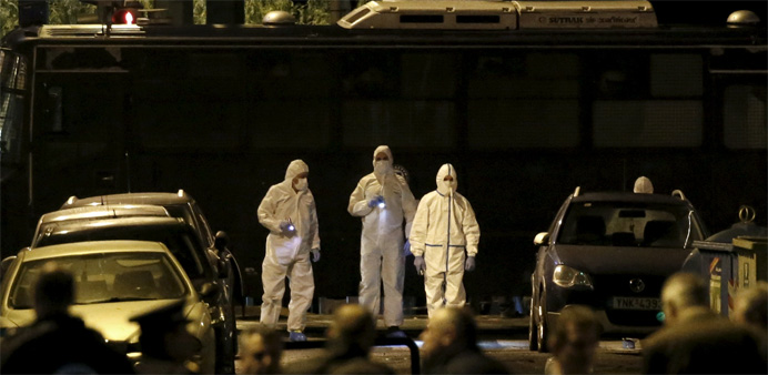 Forensic experts search for evidence on a street where a bomb exploded 