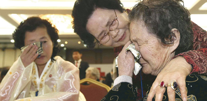 North Korean Kim Tae Un (right), 78, is comforted by her South Korean sister Kim Sa-bun (centre) during their family reunion at the Mount Kumgang reso
