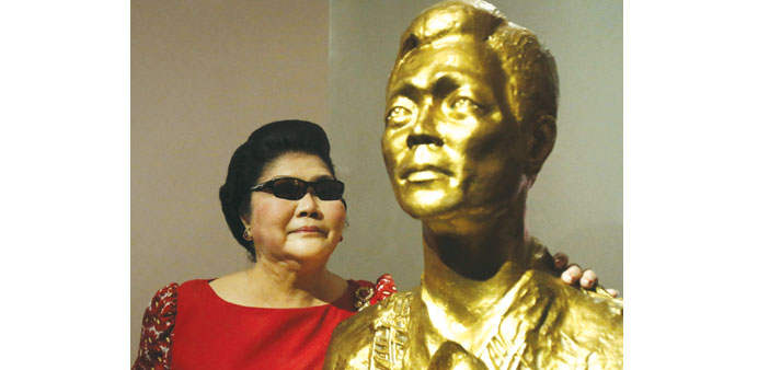 Former First Lady Imelda Marcos poses next to the bust of her late husband dictator Ferdinand Marcos in Batac, Ilocos Norte province in northern Phili