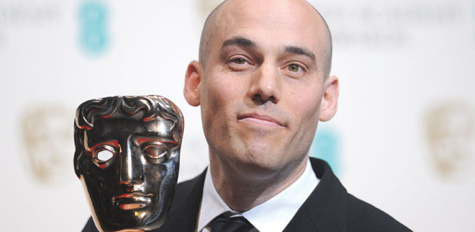 US director Joshua Oppenheimer poses with the award for a documentary for the film The Act Of Killing at the Bafta British Academy Film Awards at the 