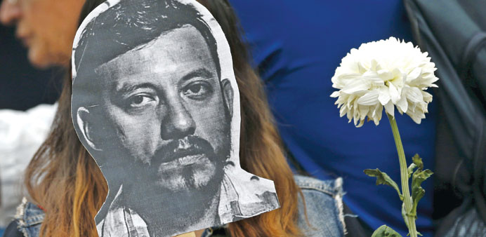 An activist holding up a picture of Espinosa during a protest against his murder in Mexico City on Sunday.