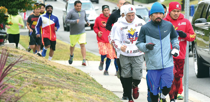 Boxer Manny Pacquiao is joined by supporters and training mates for his morning jog in Los Angeles earlier this week. (AFP)