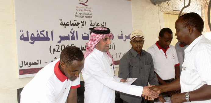 Hassan bin Hamza distributing sponsorship allowances in Somalia.