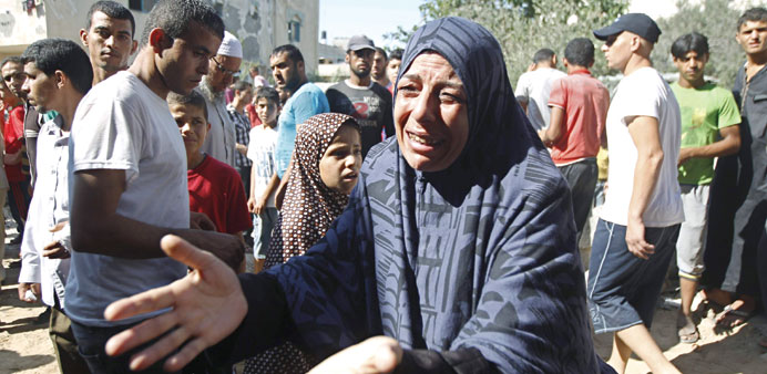 A woman reacts outside her home after  an Israeli air strike yesterday in Khan Younis.