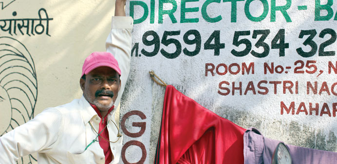  Barburo Ladsahib with the banner of his school in Dharavi.
