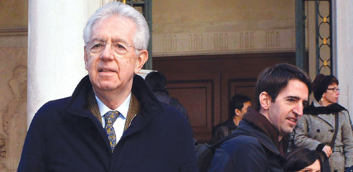 Outgoing Italian Prime Minister Mario Monti (left) walks in front of La Fenice theatre during a private visit in Venice this week. Monti said last wee