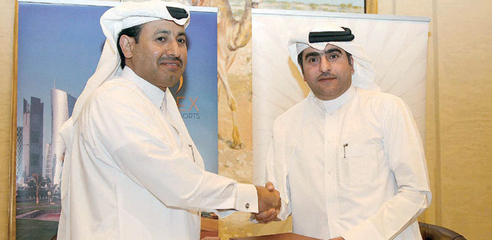 Hamad Abdulla al-Mulla and Saeed Abdulla al-Amer al-Kaabi at the signing ceremony.
