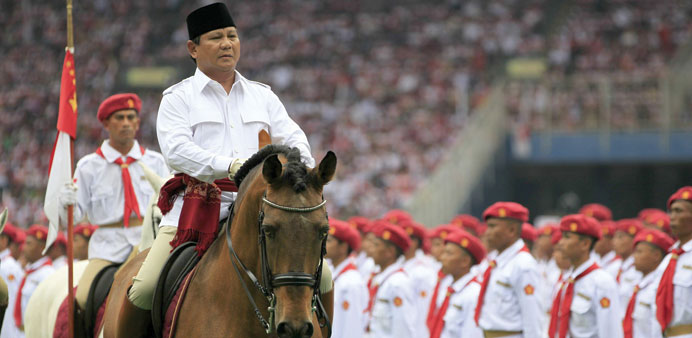 Prabowo Subianto, presidential candidate of the Great Indonesia Movement (Gerindra) Party, rides a horse during a campaign rally at a stadium in Jakar