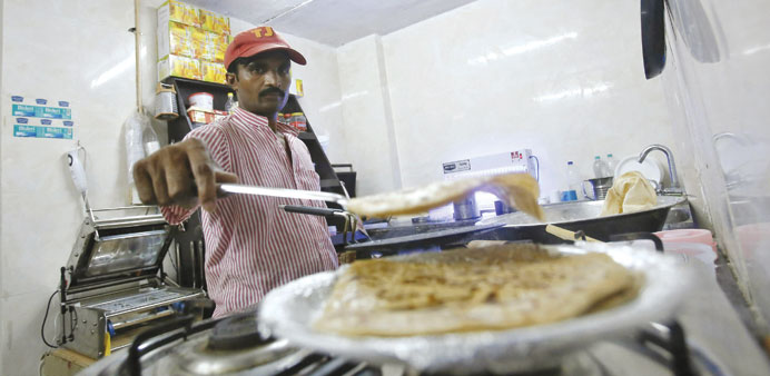 An inmate prepares food inside the kitchen of a restaurant run by the Tihar Jail authorities on Jail Road in Delhi.