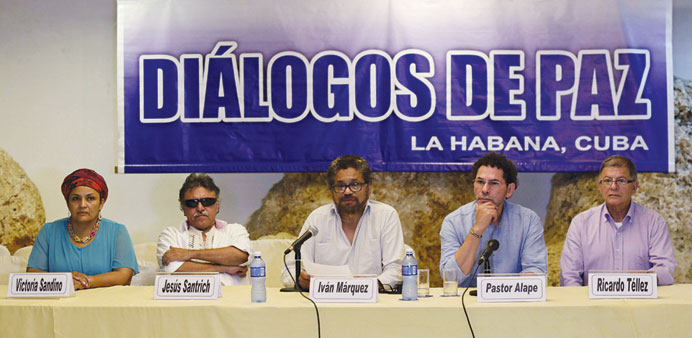Revolutionary Armed Forces of Colombia (Farc) lead negotiator Ivan Marquez (centre) reads a document while flanked by fellow Farc members in Havana, C