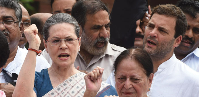 Congress president Sonia Gandhi and vice president Rahul Gandhi shout slogans during a protest by Congress Party Members of Parliament at the Mahatma 