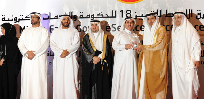 A Doha Bank executive receiving the u201ceBanking 2013 Excellence Awardu201d in Dubai.