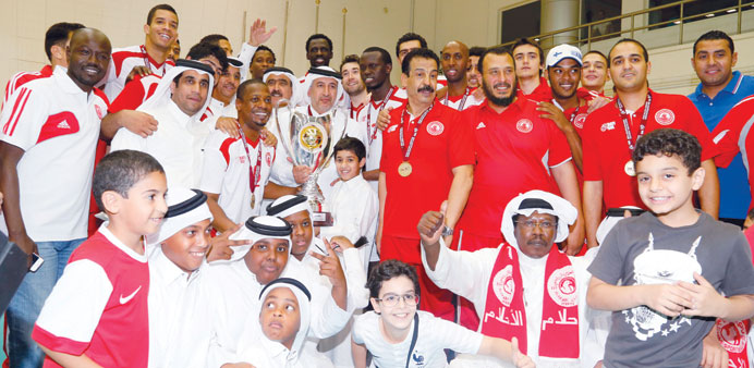 Al Arabi players and officials celebrate with the winnersu2019 trophy after beating El Jaish in the Qatar Cup volleyball final at Al Arabi Sports Hall yes