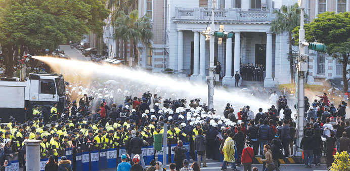 Police use water cannons to disperse demonstrators near Taiwanu2019s government headquarters in Taipei yesterday.