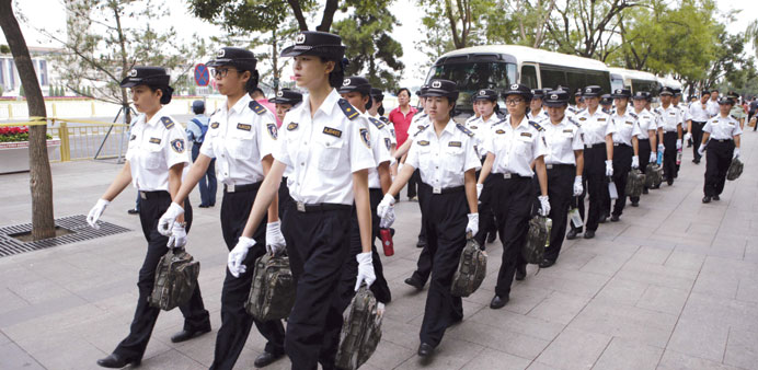 Female security staff arrive for work next to Beijingu2019s Tiananmen Square.