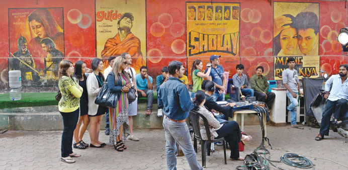 Tourists watch a live shoot on a Bollywood film set in Mumbai.