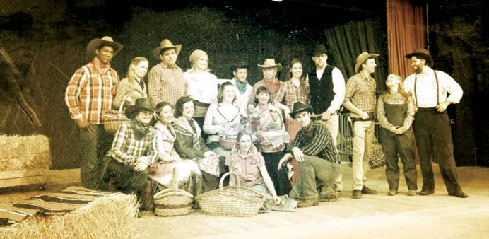 Cast of Oklahoma! gather for the box social.