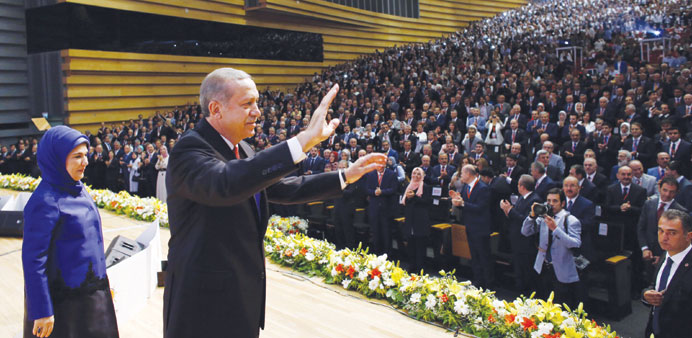 Erdogan waves to members of Turkeyu2019s ruling Justice and Development Party (AKP), flanked by his wife Emine, at a ceremony in Ankara for the announceme
